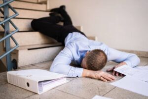 Man on suit fell down from the stairs.